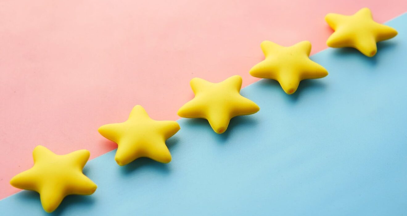 five yellow stars on blue and pink background